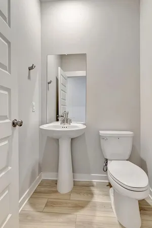 a bathroom with a sink toilet and a mirror