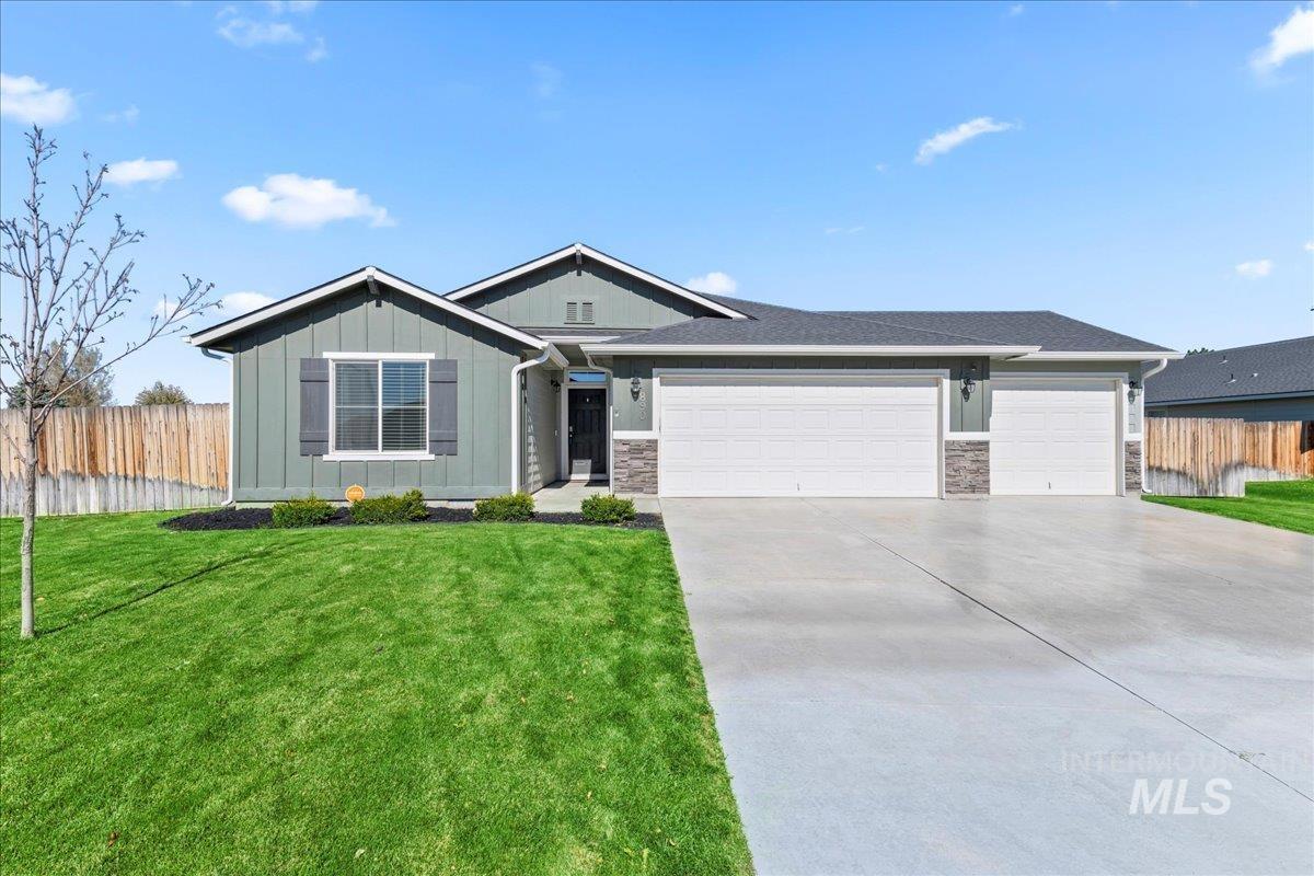 890 Lago Street Mountain Home, ID 83647 - Photo 1 of 1 View of front of property with board and batten siding, a garage, driveway, and stone siding