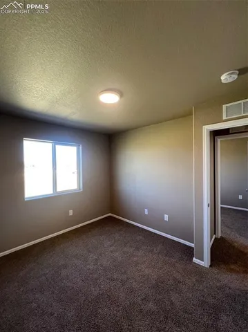 an empty room with closet and window