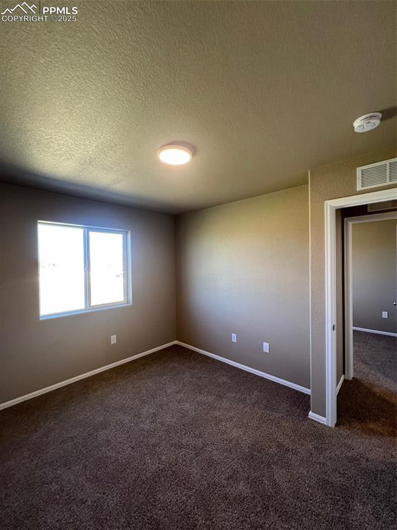 1874 Sandtoft Heights Colorado Springs, CO 80951 - Photo 11 of 31 an empty room with a empty space and windows