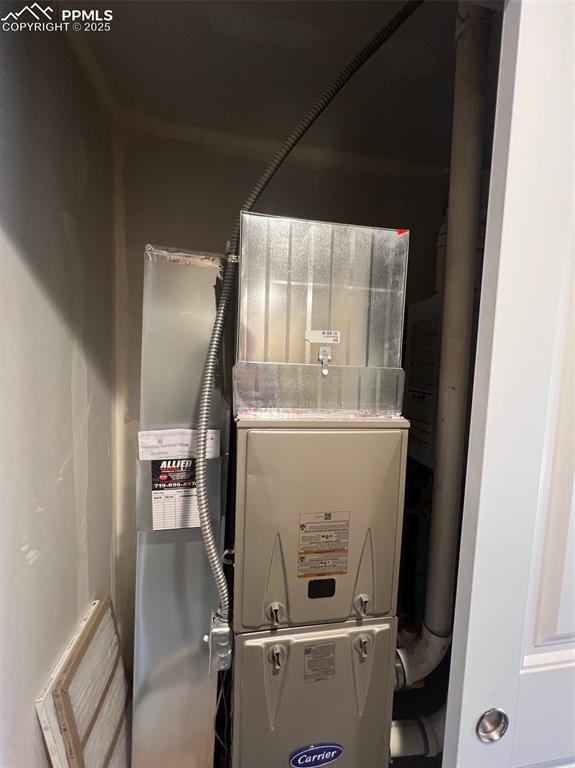 1874 Sandtoft Heights Colorado Springs, CO 80951 - Photo 19 of 31 a room with water heater and a cabinet
