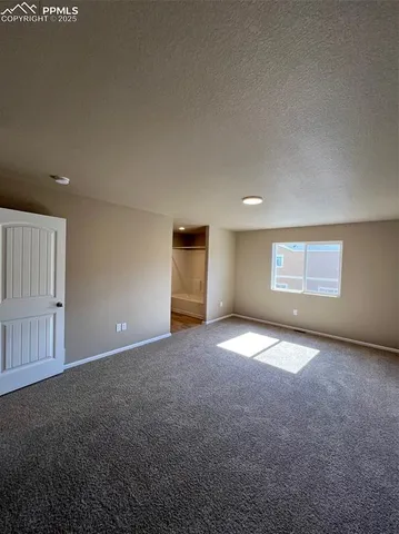 an empty room with an entrance to other room