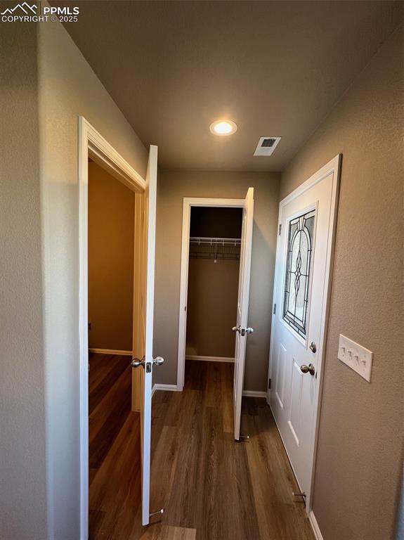 1874 Sandtoft Heights Colorado Springs, CO 80951 - Photo 5 of 31 a view of a hallway with wooden floor and staircase