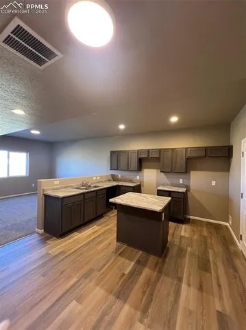 a kitchen with stainless steel appliances granite countertop a stove and a sink