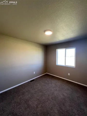 an empty room with a empty space and windows
