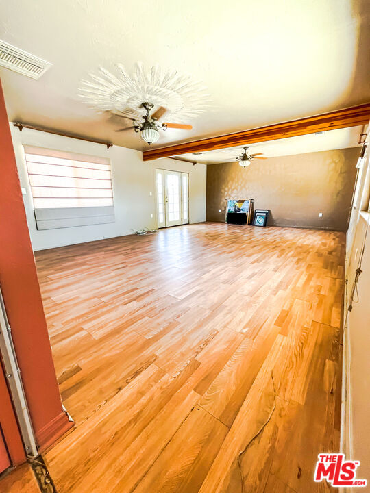 1001 South McCall Street Ridgecrest, CA 93555 - Photo 11 of 27 a view of a room with wooden floor and ceiling fan