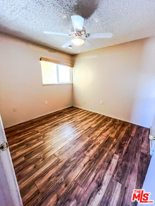 1001 South McCall Street Ridgecrest, CA 93555 - Photo 14 of 27 a view of wooden floor and chandelier in a room
