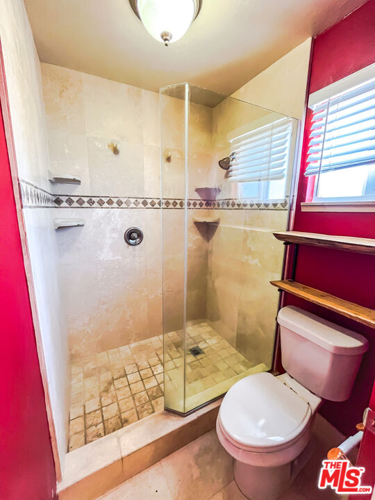 1001 South McCall Street Ridgecrest, CA 93555 - Photo 20 of 27 a bathroom with a granite countertop toilet sink and shower