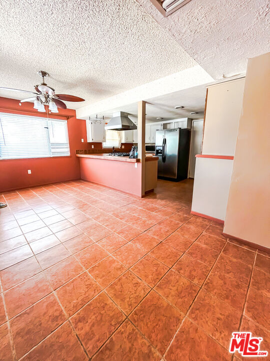 1001 South McCall Street Ridgecrest, CA 93555 - Photo 4 of 27 a kitchen with a sink and a refrigerator