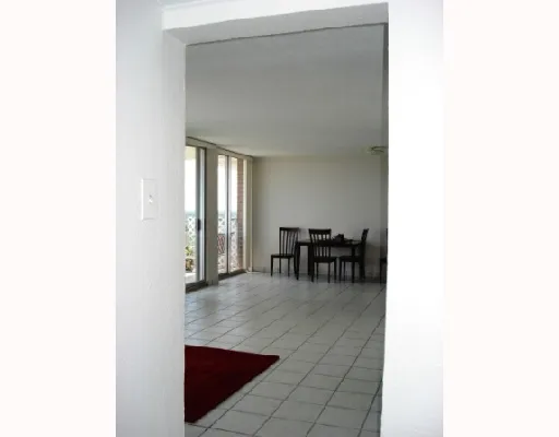 a view of a hallway with chairs and a potted plant