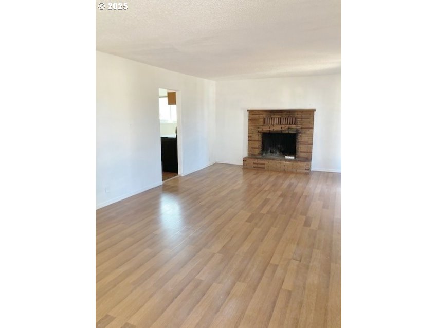 727 Southwest 28th Street Pendleton, OR 97801 - Photo 4 of 12 a view of a livingroom with wooden floor and staircase