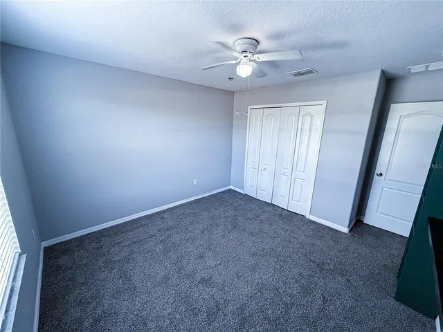 a view of an empty room with a fan
