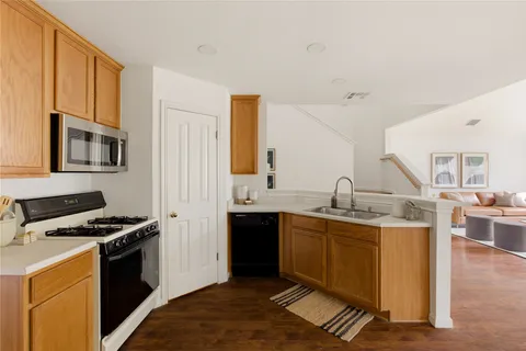 a kitchen with a sink cabinets and wooden floor
