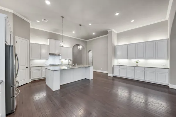 a view of empty room with wooden floor and fireplace