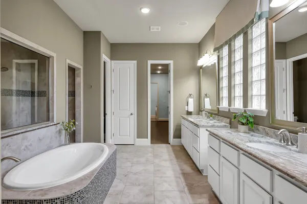 a view of a bathroom with tub and shower