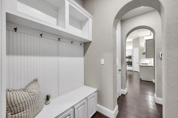 a kitchen with white cabinets and window