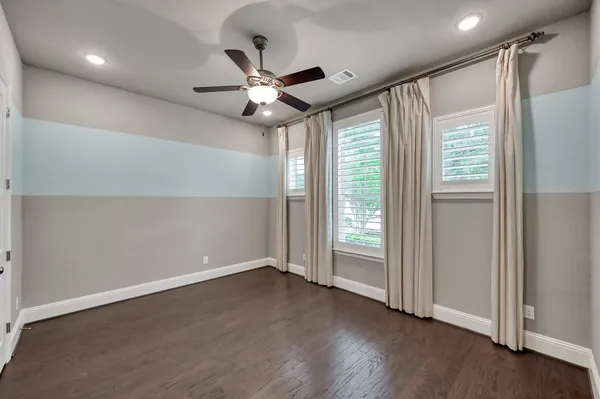 a view of an empty room with a fireplace and a window