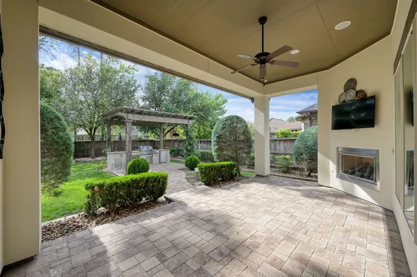 a view of a porch with furniture and a garden