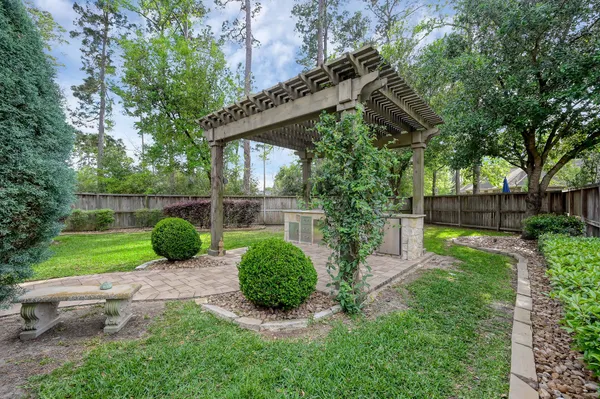an aerial view of house with yard and parking spaces