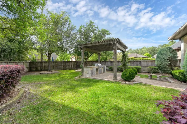an aerial view of a house with a garden and lake view