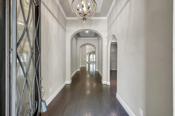 a kitchen with stainless steel appliances a kitchen island hardwood floor and a sink
