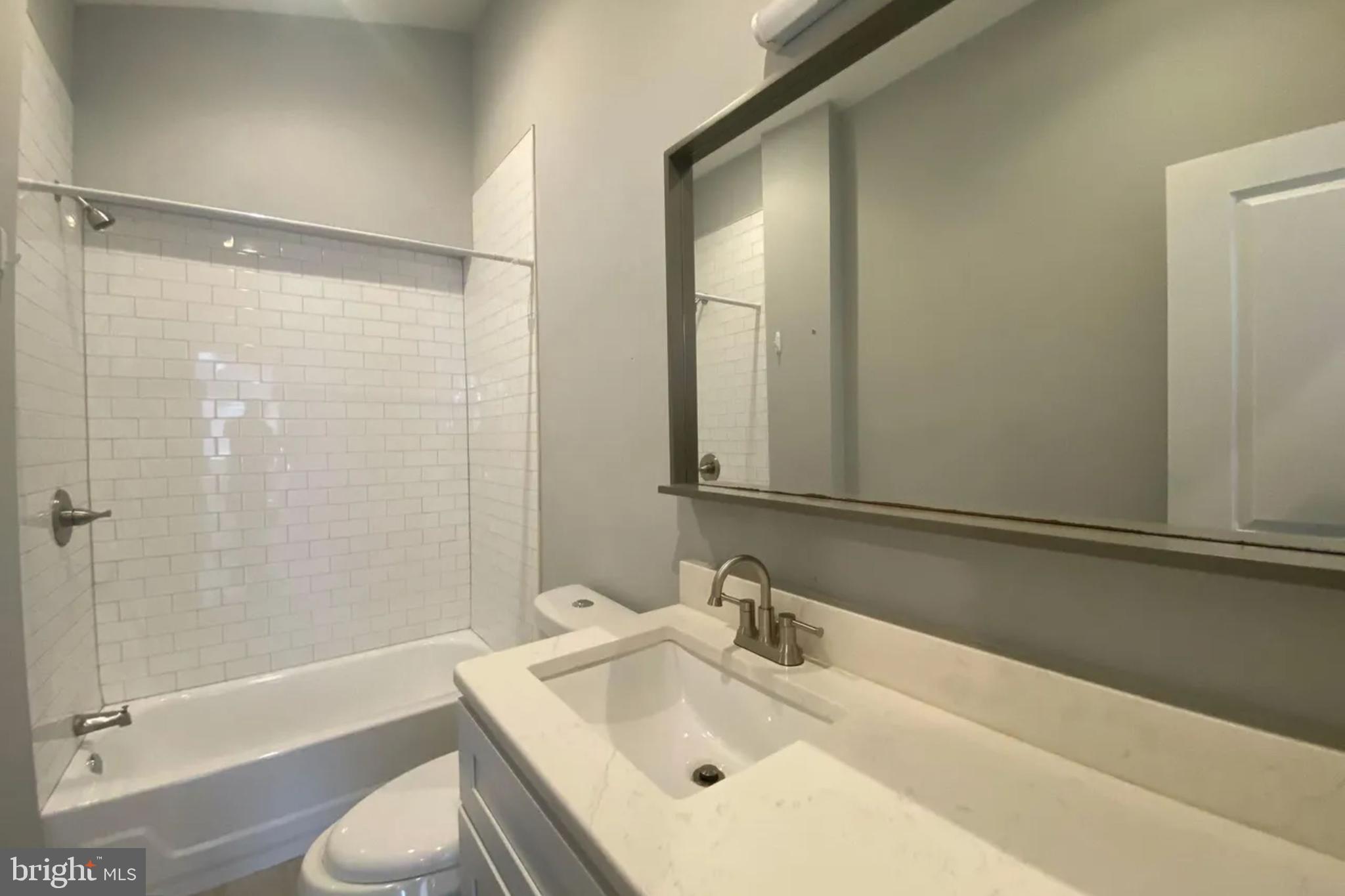 1616 Spruce Street, Unit 3R Philadelphia, PA 19103 - Photo 2 of 9 a bathroom with a sink and a mirror
