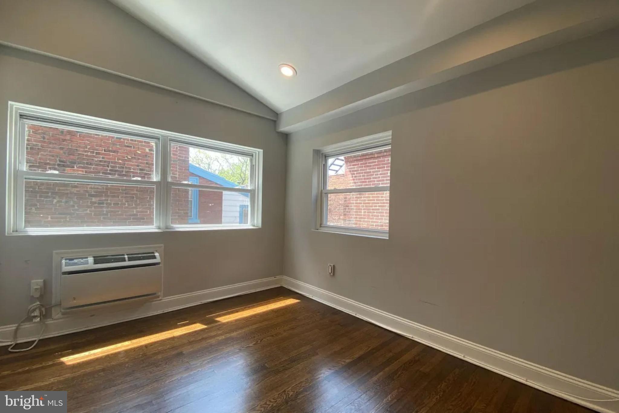 1616 Spruce Street, Unit 3R Philadelphia, PA 19103 - Photo 7 of 9 an empty room with wooden floor and windows