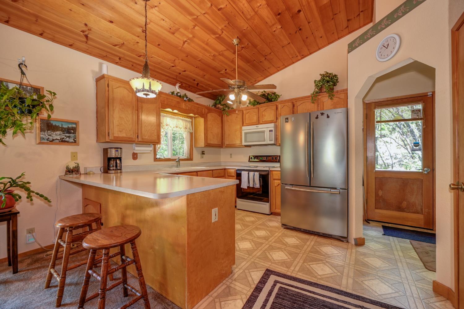 23998 Stable Road Sonora, CA 95370 - Photo 12 of 41 a large kitchen with a large window cabinets and stainless steel appliances