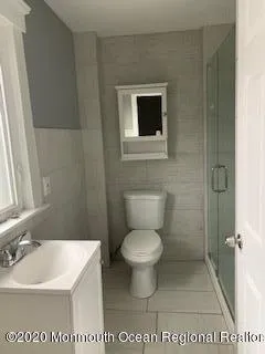 a bathroom with a toilet and a shower