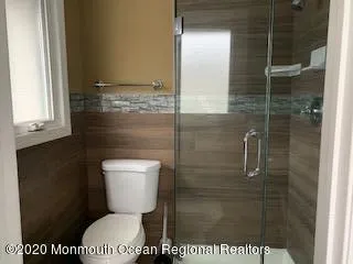 a bathroom with a toilet and a shower