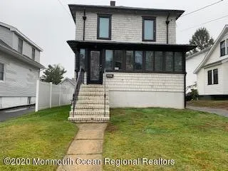 a living room with furniture and a hard wood floor