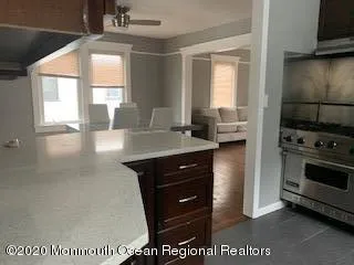 a kitchen with a wooden floor and a stove top oven
