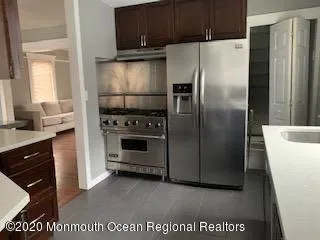 a kitchen with a refrigerator a stove a microwave and cabinets