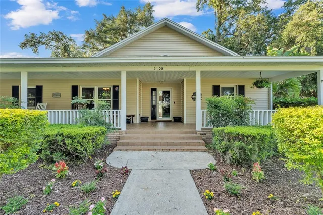a view of a house with potted plants