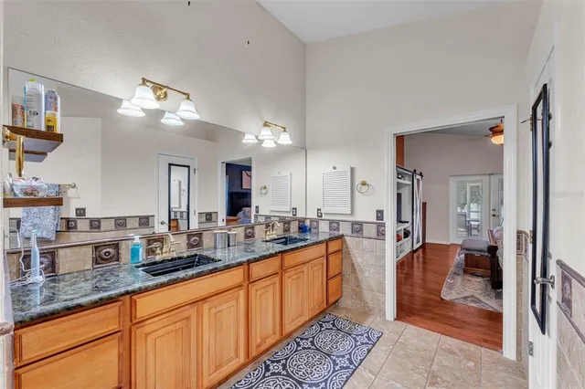 a large bathroom with double vanity a sink and a mirror