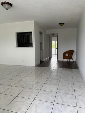 a view of empty room with a sink and lounge chair