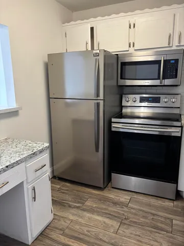 a kitchen with appliances and cabinets