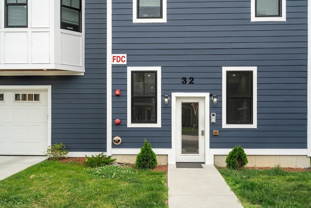 32 Pearl Street, Unit 4 Boston, MA 02125 - Photo 34 of 35 a front view of a house with a yard