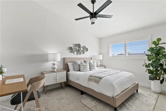 a bedroom with a bed and a potted plant