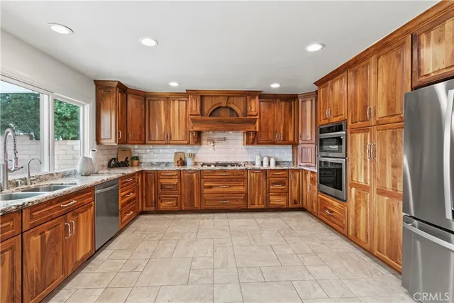 a kitchen with granite countertop stainless steel appliances and cabinets