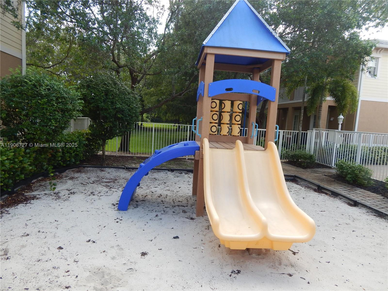 4622 Southwest 75th Way, Unit 102 Davie, FL 33314 - Photo 11 of 16 a view of a backyard with a slide