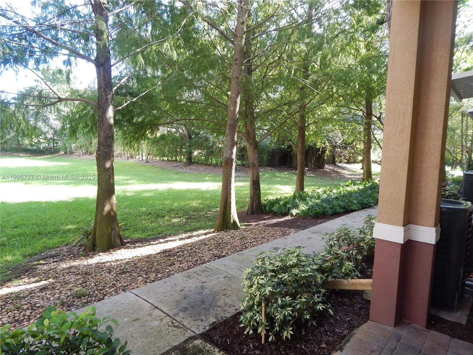 4622 Southwest 75th Way, Unit 102 Davie, FL 33314 - Photo 14 of 16 a front view of a house with garden