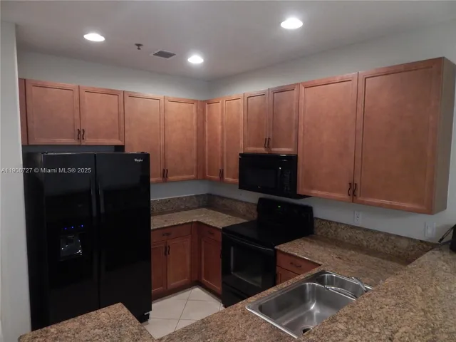 a kitchen with a refrigerator and a stove
