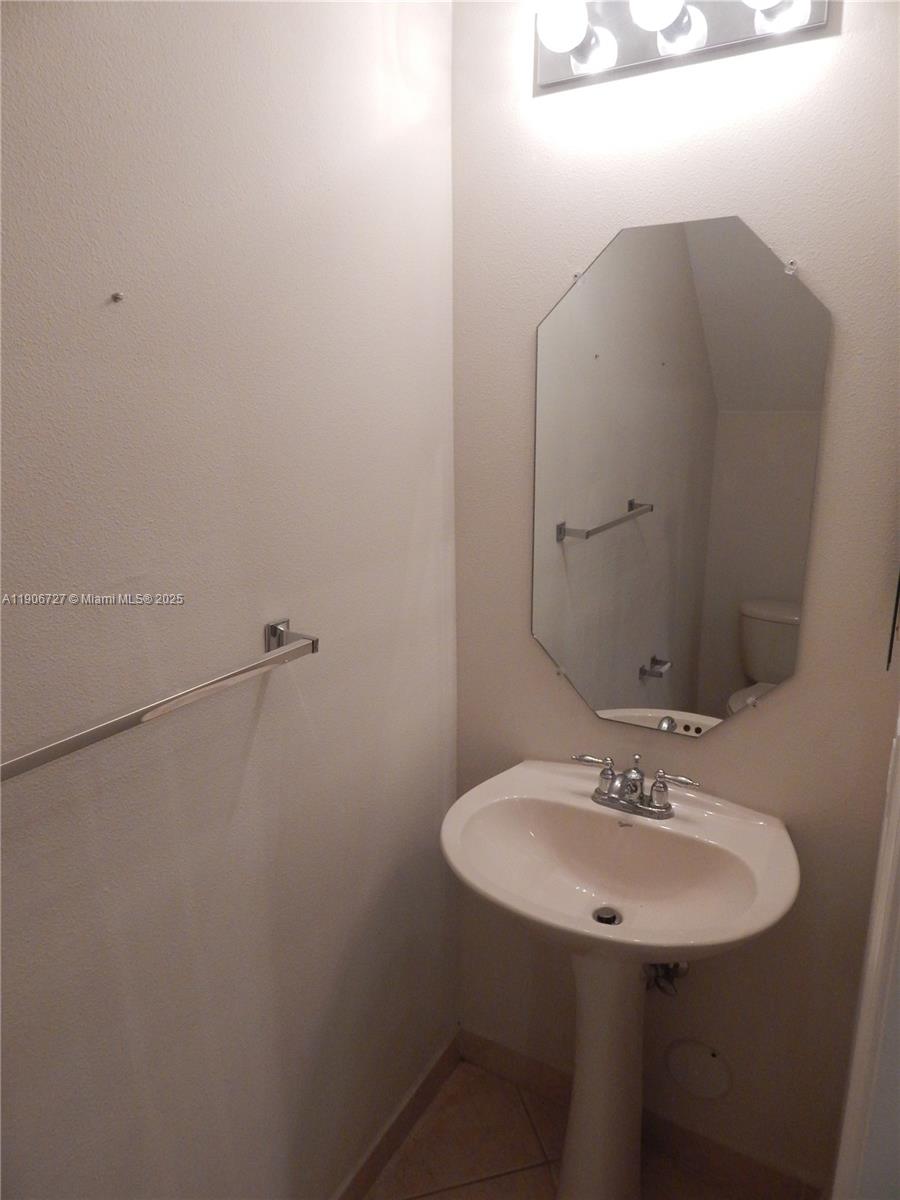 4622 Southwest 75th Way, Unit 102 Davie, FL 33314 - Photo 4 of 16 a bathroom with a sink and mirror