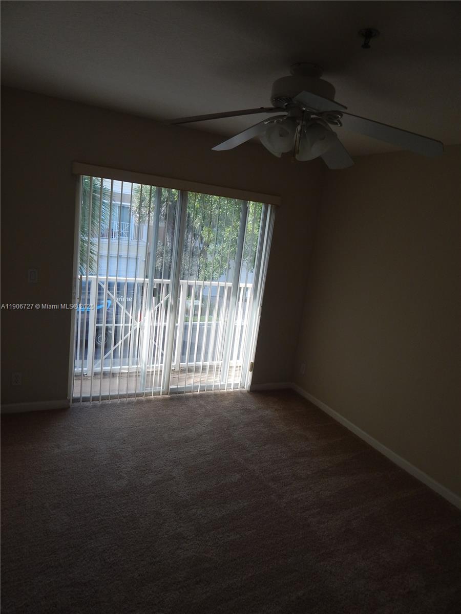 4622 Southwest 75th Way, Unit 102 Davie, FL 33314 - Photo 5 of 16 a view of an empty room with a window