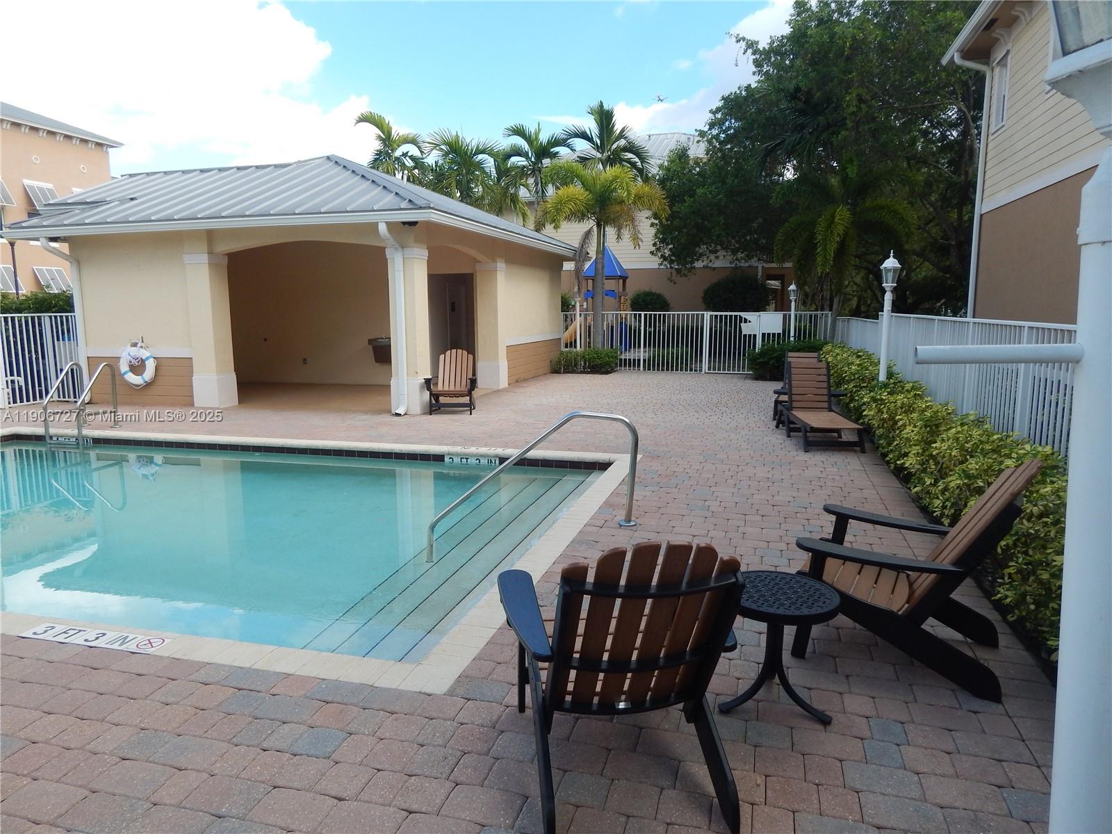 4622 Southwest 75th Way, Unit 102 Davie, FL 33314 - Photo 10 of 16 a backyard of a house with table and chairs
