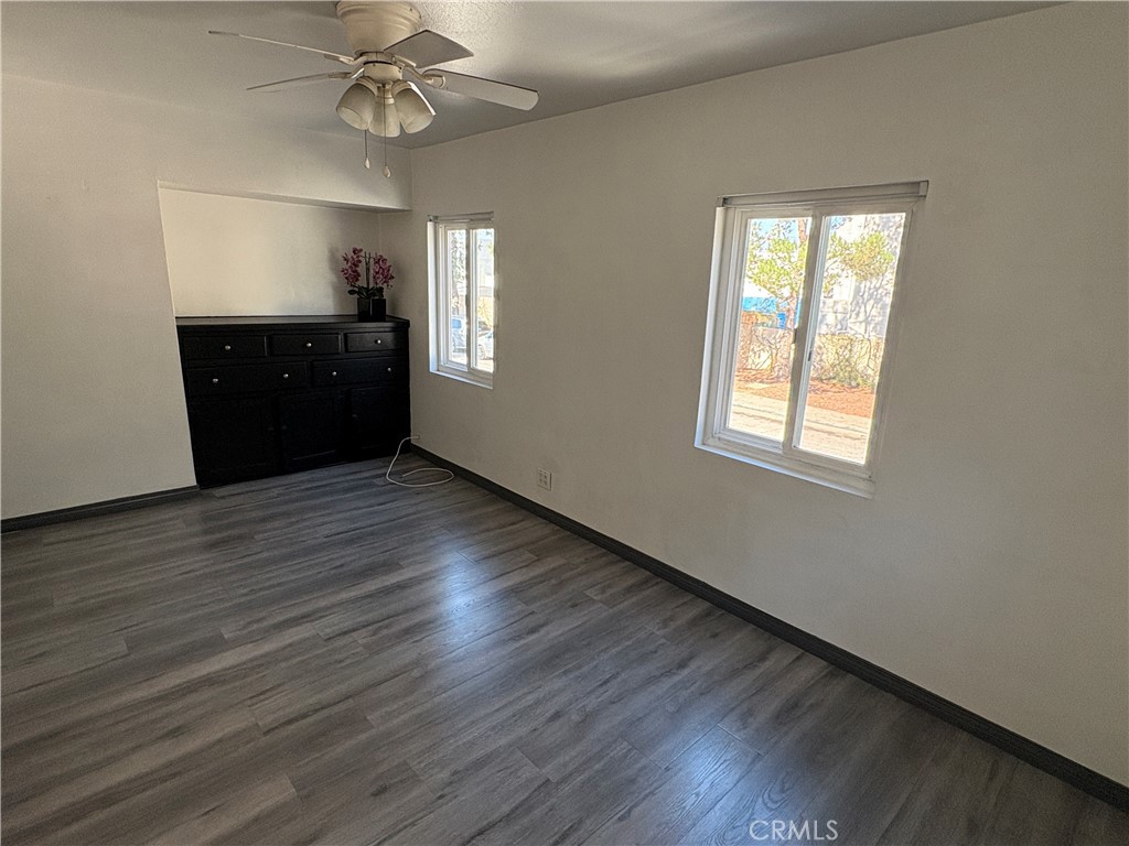9148 Verner Street, Unit A Pico Rivera, CA 90660 - Photo 4 of 14 an empty room with wooden floor fan and windows