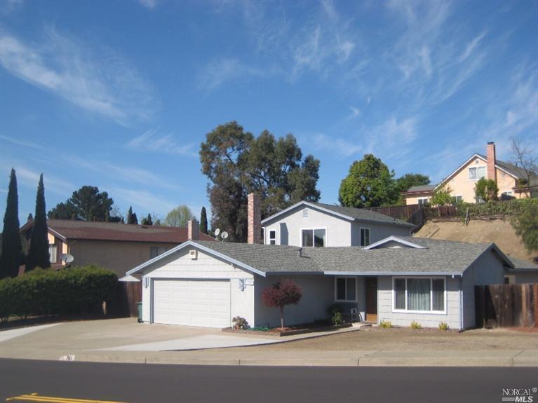 793 Coral Drive Rodeo, CA 94572 - Photo 1 of 1 a front view of a house with a yard and garage
