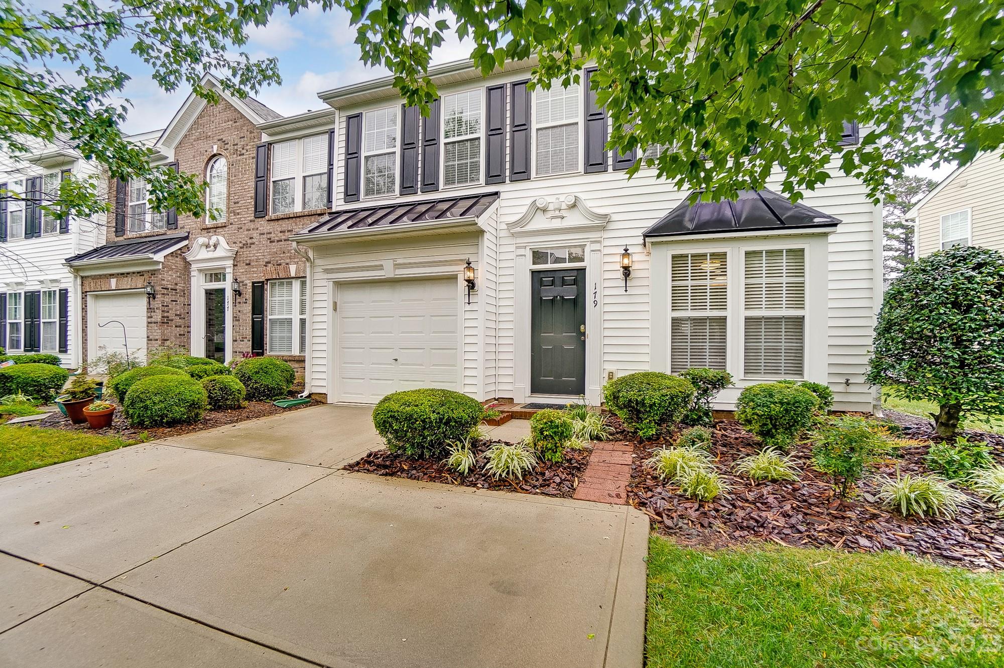 179 Snead Road Fort Mill, SC 29715 - Photo 1 of 48 a front view of a house with garden and trees