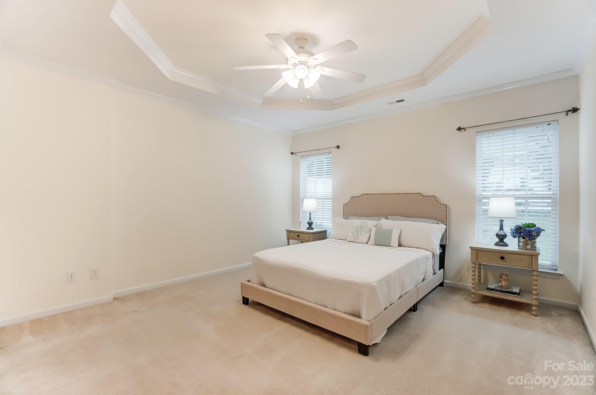 179 Snead Road Fort Mill, SC 29715 - Photo 12 of 48 a bedroom with a bed and a chandelier